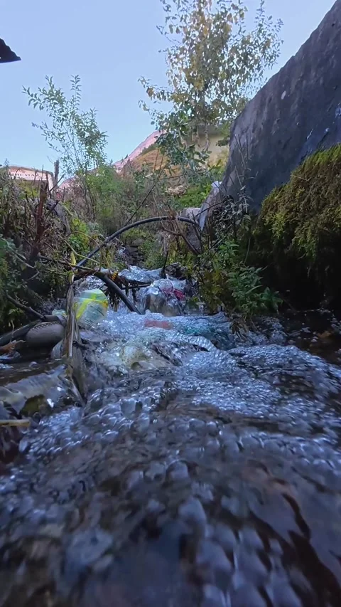 Low Angle Close Up of a Small Stream Rushing Over Rocks in a Rural Mountain Stock Footage 329829813
