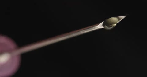 Low-angle Close-up of Syringe Tip Dripping Stock Footage 285398244