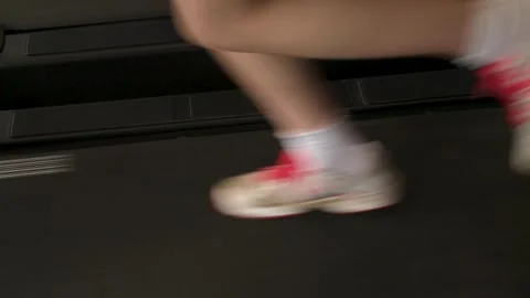 Low-Angle Close-Up of Trainers Running on Treadmill Stock Footage 296846028
