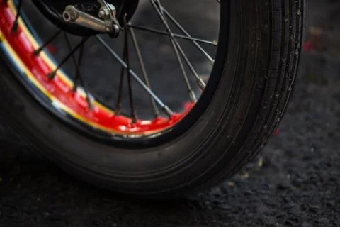 Low Angle Close Up View of Vintage Motorcycle Front Tire Tread and Spoke Rim Stock Photos