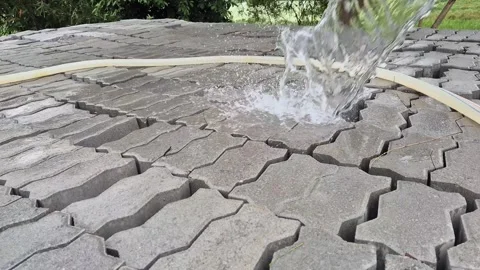 Low Angle Close Up Of Water Hose Curing Concrete Interlocking Paver Blocks Stock Footage 340113807
