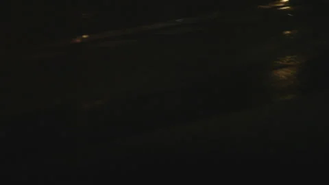 Low Angle Close Up Wet Asphalt Road At Night With Passing White Lines Stock Footage 328230973