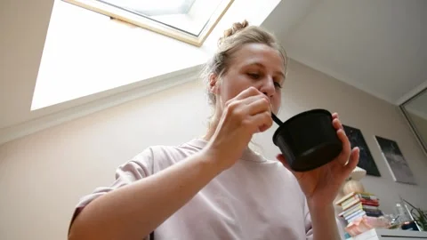 Low angle close-up of a woman eating miso soup with a spoon Video stock 346638148
