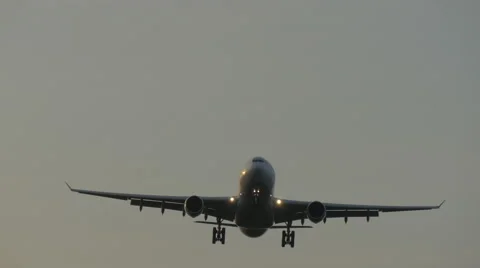 Low angle closeup of an airplane descending to touchdown. Video stock 61793276