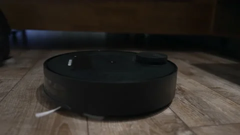 Low angle closeup of a small circular vacuum cleaner Video stock 171919597