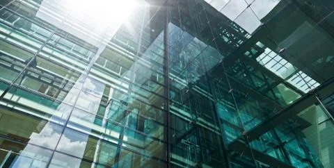 Low angle closeup view of modern green glass facade office building Stock Photos