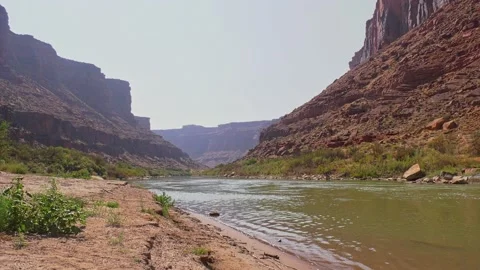 Low angle Colorado river flowing through valley in mountains near Moab Stock Footage 145003574