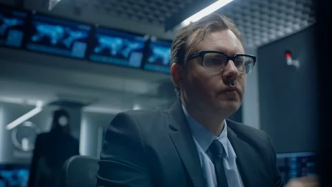 Low Angle of the Concerned Specialist Working on Computer in the Monitoring Stock Footage 94600190