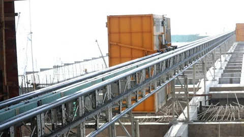 Low angle of construction site building with scaffolding elevator moving down Stock Footage 109611803