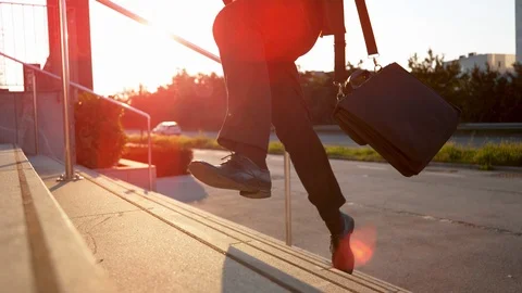LOW ANGLE: Corporate executive rushing to work and losing legal paperwork. Stock Footage 101333374