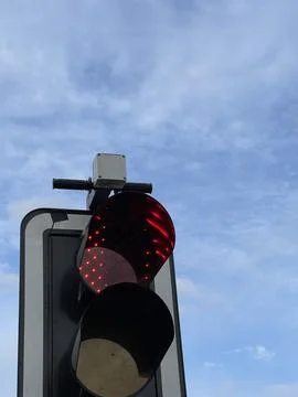 Low angle cropped shot of red traffic lights under blue sky Stock Photos
