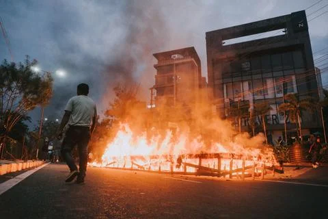 Low angle of crowd making fire on the street at CAB Protest in Guwahati, Assam, Stock Photos