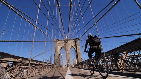 Low Angle Cyclist Passing on Brooklyn Bridge, New York City Video stock 116720400