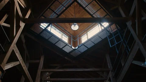 Low Angle of daylight pouring through skylight into a dim horse stables or barn Stock Footage 117744090