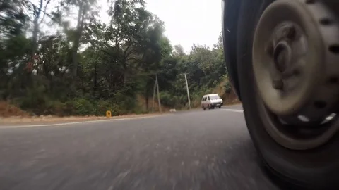 Low angle deflated car tire driving on the road, rainy day Video stock 128978452