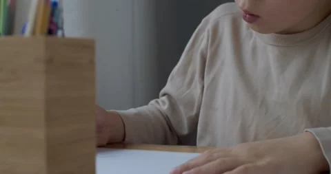 Low angle detailed view of cute boy drawing at home slow motion. Blonde kid Stock Footage 147177918