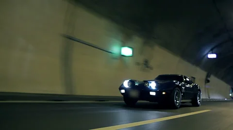 Low angle diagonal shot of Corvette driving through the tunnel Stock Footage 33004120