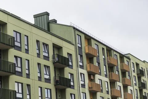 Low-angle diagonal view of a modern multi-colored apartment building row fe.. Stock Photos