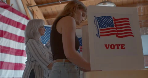 Low Angle of a diverse group of voters voting at a polling station Stock Footage 274962356