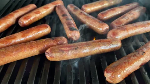 Low angle dogs on a hot grill Stockbeeldmateriaal 337576557