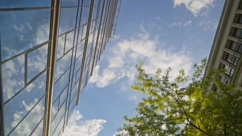 Low angle dolly movement between modern glass skyscrapers in business district Stock Footage 335731011
