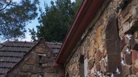 Low angle dolly shot of stone church wall and roof Stock Footage 341911255