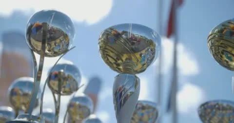 A Low-angle Dolly / Slider Shot of Trophies in an Outdoor Championship Stock Footage