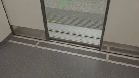 Low angle down view to underground or subway carriage door while closing re.. Видео 337007677