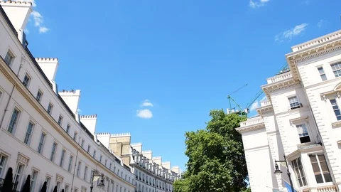 Low angle driving view on Grosvenor Place street terraced row houses London Vidéo 108604657
