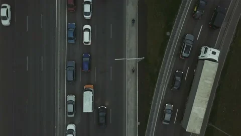 Low-angle drone flight over a massive intersection during early evening rush Stock Footage 154570960