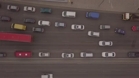 Low-angle drone flight over a massive intersection during early evening rush Stock Footage 155098739