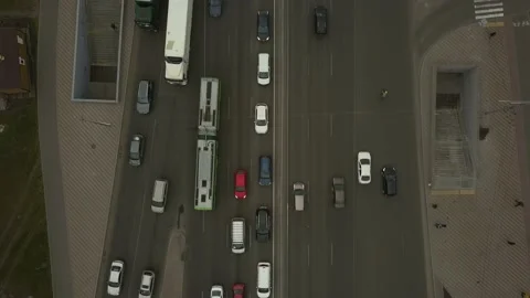 Low-angle drone flight over a massive intersection during early evening rush Stock Footage 155165042