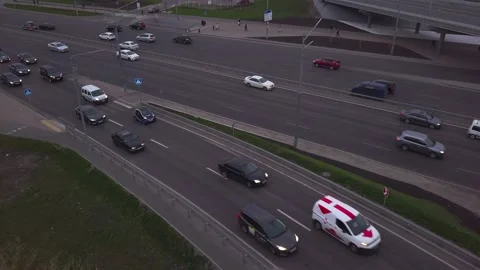 Low-angle drone flight over a massive intersection during early evening rush Stock Footage 160413100