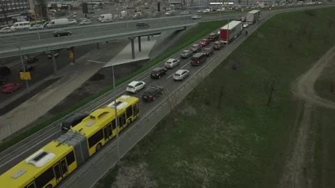 Low-angle drone flight over a massive intersection during early evening rush Stock Footage 241893450