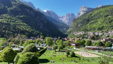 Low Angle Drone Flight Over Green Trees Towards Dolomites Peaks 库存影片 337333754