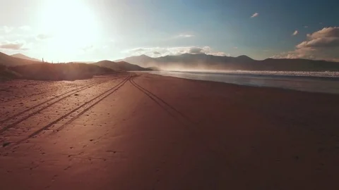 Low angle drone footage of beach and ocean at sunset Stock Footage 70359047