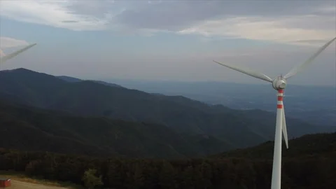 Low-angle drone pass beneath rotating turbine Stock Footage 322808054