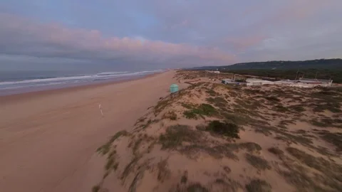 Low-angle drone shot captures ocean waves meeting shore Stock Footage 344543542