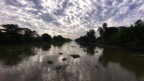 Low angle drone shot gliding smooth over river surface at sunrise Stock Footage 342924384