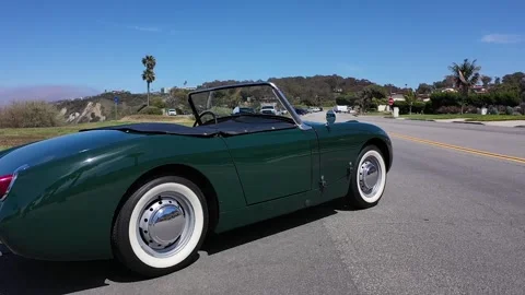 Low Angle Drone Shot Panning Past Classic Green Austin-Healey Sprite Convertible Stock Footage 340867075