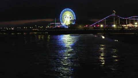 Low Angle Drone Shot Of Waves Of Santa Monica Pier At Night 4K 24FPS Stock Footage 195557779