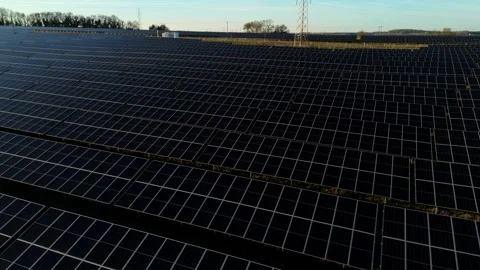 Low Angle Drone Tracking Shot close Above Glass Surface of Solar Array in Stock-Footage 342855420