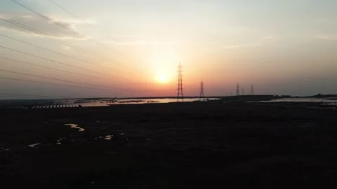 Low-angle-drone-transmission-tower-solar-farm-sunset Stock Footage 342804274