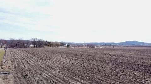 Low angle drone view, flying backward over an empty agricultural field Stock-Footage 164798756