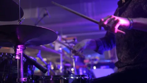LOW ANGLE OF DRUMMER WITH COOL SHIRT PLAYING DRUMS, SLOW MOTION Stock Footage 128374040