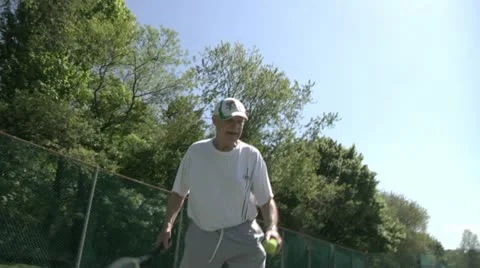 Low Angle of Elderly Man Playing Tennis Stock Footage 11016612