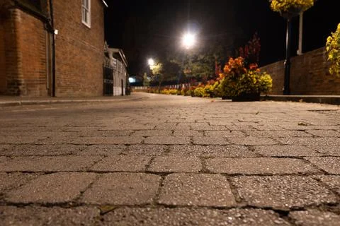 Low angle of an empty cobbled street on a summer's night. UK Stock Photos