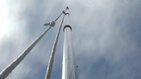 Low Angle Empty Flagpole With Rope Swaying Blow By The Wind On Cloudy Day Stock Footage 153558864
