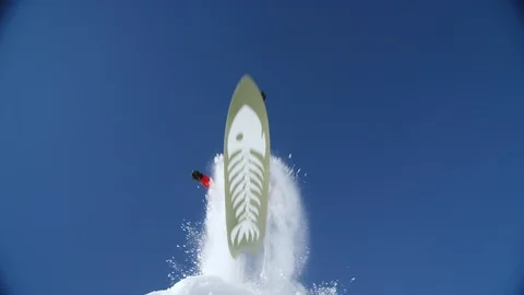 Low angle of enthusiastic snowboarder jumping and splashing white powder snow Video stock 116783753