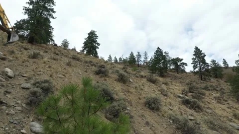 Low Angle Excavator Driving Mountain Side Drone Shot Stock Footage 146553405